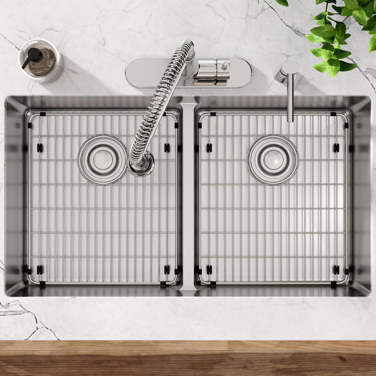 Stainless steel double bowl sink with two equal-sized basins, grid inserts, circular drains, sprayer hose, and divider, viewe