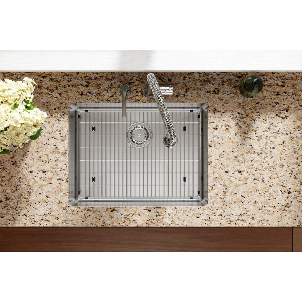 Stainless steel single bowl sink with vertical ridged interior, two mounting holes, sprayer faucet, and drain strainer instal
