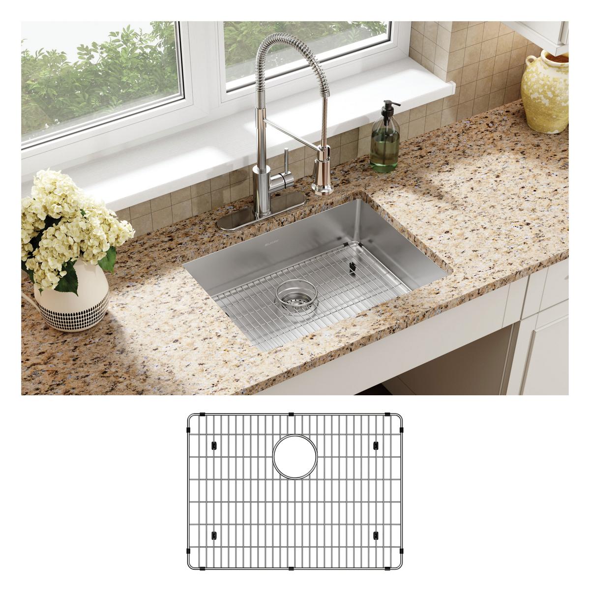 Stainless steel rectangular sink with single bowl mounted in granite countertop, paired with chrome faucet and protective gri