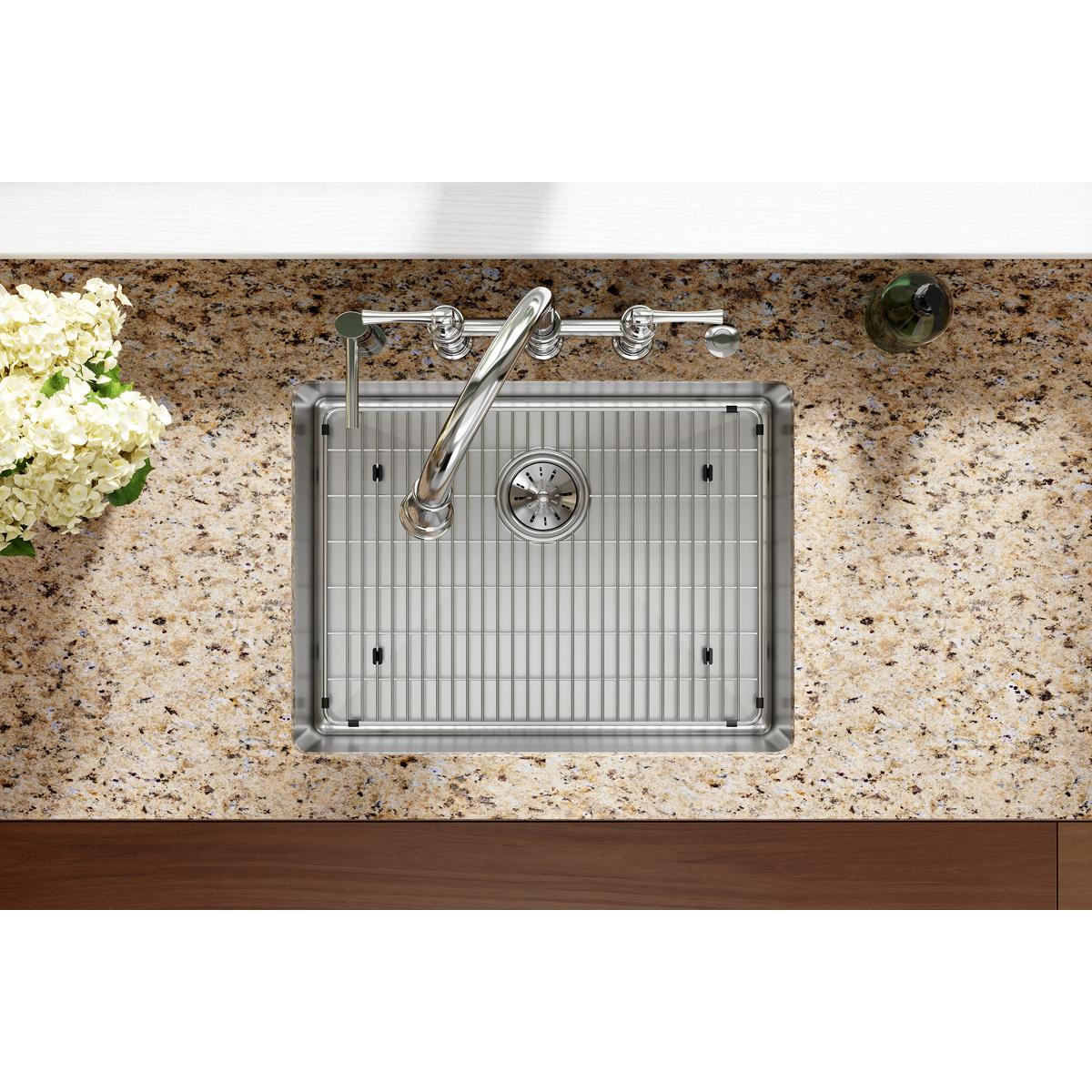 Stainless steel single bowl sink with vertical ribbed interior, chrome faucet with five holes, and drain strainer mounted in 