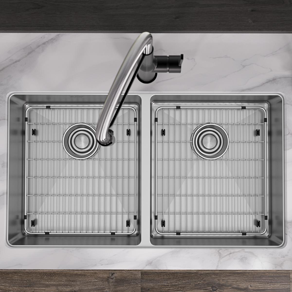 Overhead view of stainless steel double bowl sink with two equal basins, grid inserts, and chrome faucet on marble countertop