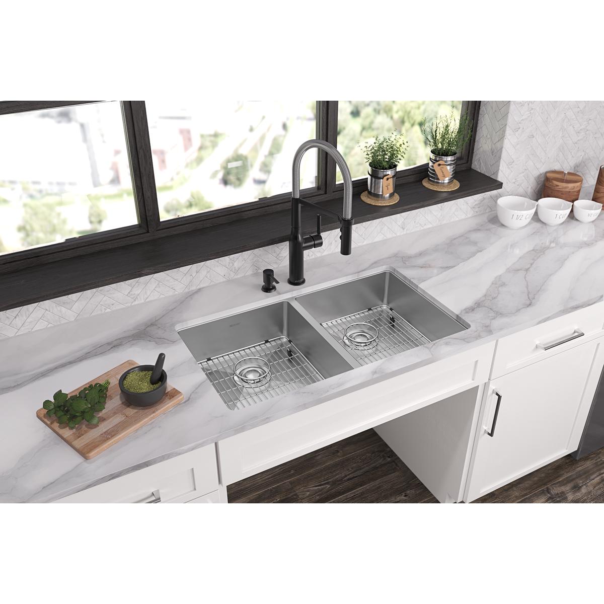 Stainless steel dual bowl undermount sink with two faucet holes and matching grid inserts installed in white kitchen countert