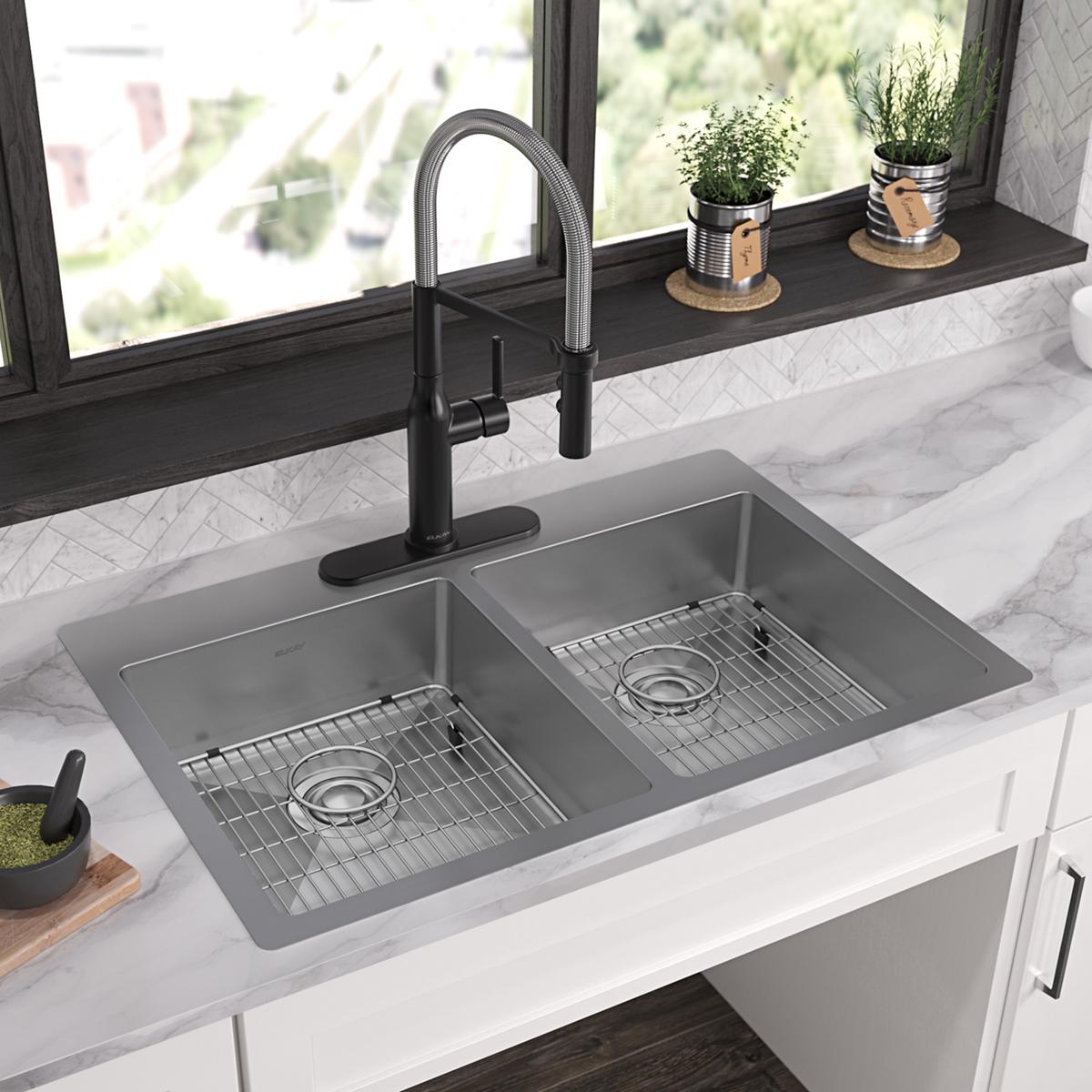 Stainless steel double bowl sink with two equal compartments, drain grids, black pull-down faucet, and marble countertop in k