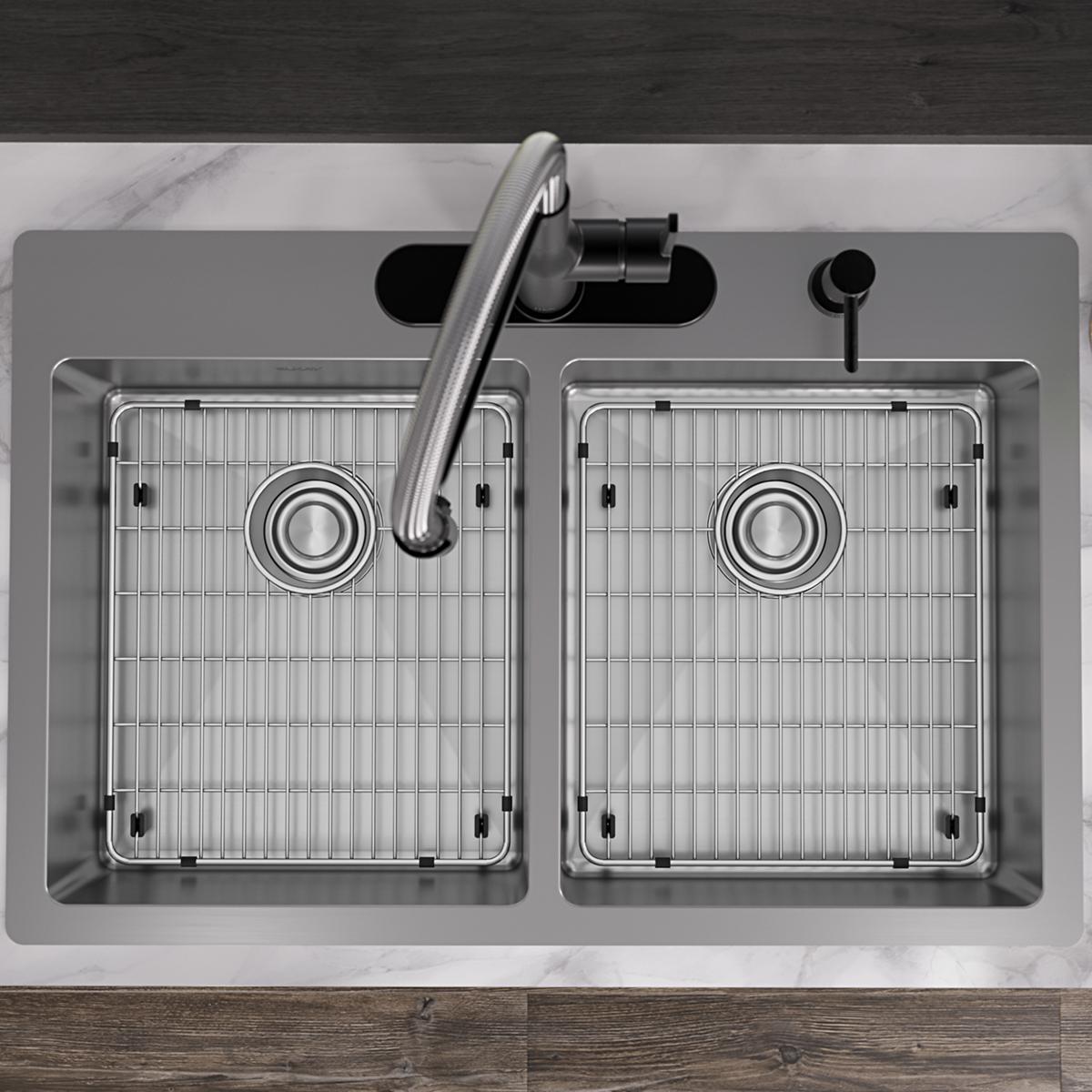 Stainless steel double bowl sink with two equal compartments, grid inserts, faucet, and soap dispenser mounted in countertop.