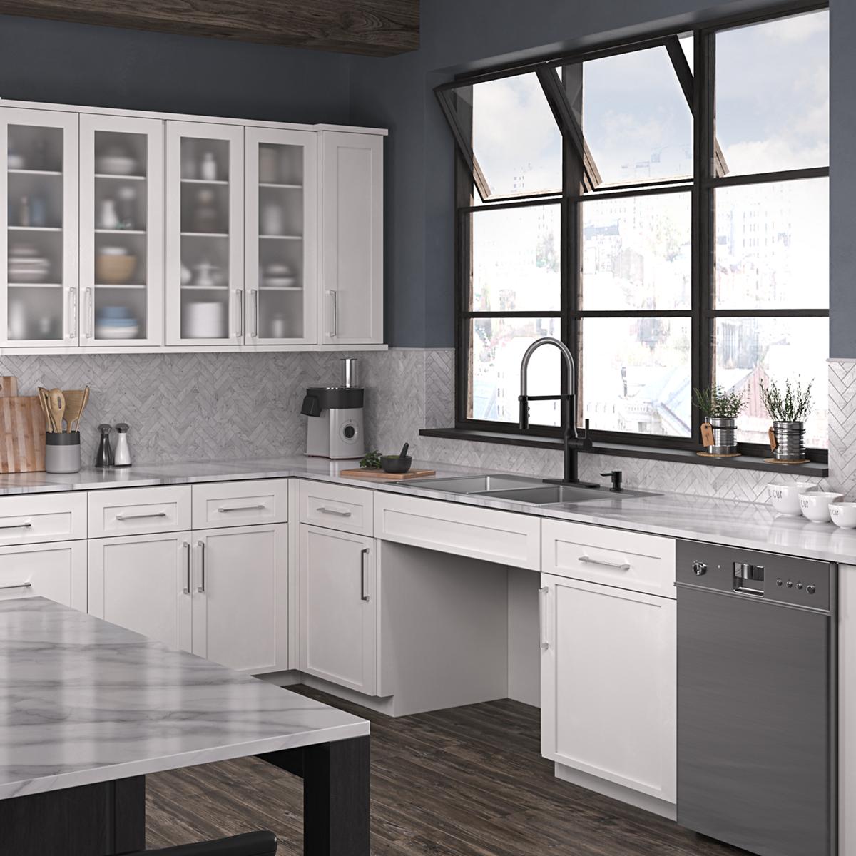 Stainless steel double bowl kitchen sink with four holes and black pull-down faucet installed in white cabinetry.