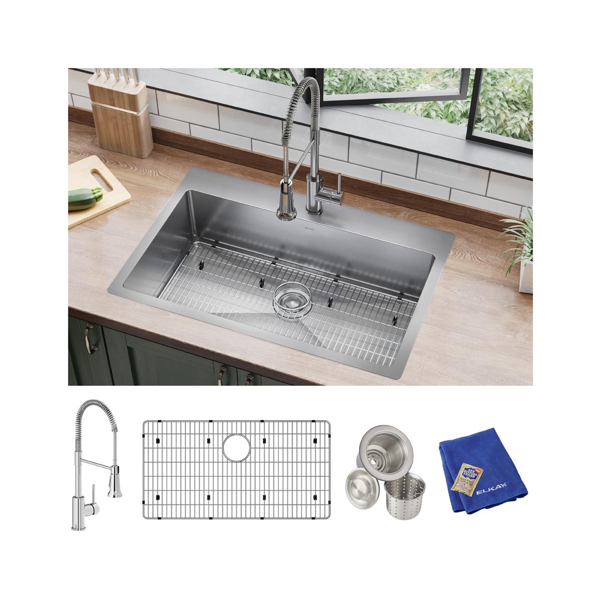 Stainless steel single bowl sink installed in countertop with included faucet, grid, strainer, and cloth.