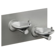 Stainless steel wall-mounted bi-level drinking fountain with two circular basins and push-button spouts.