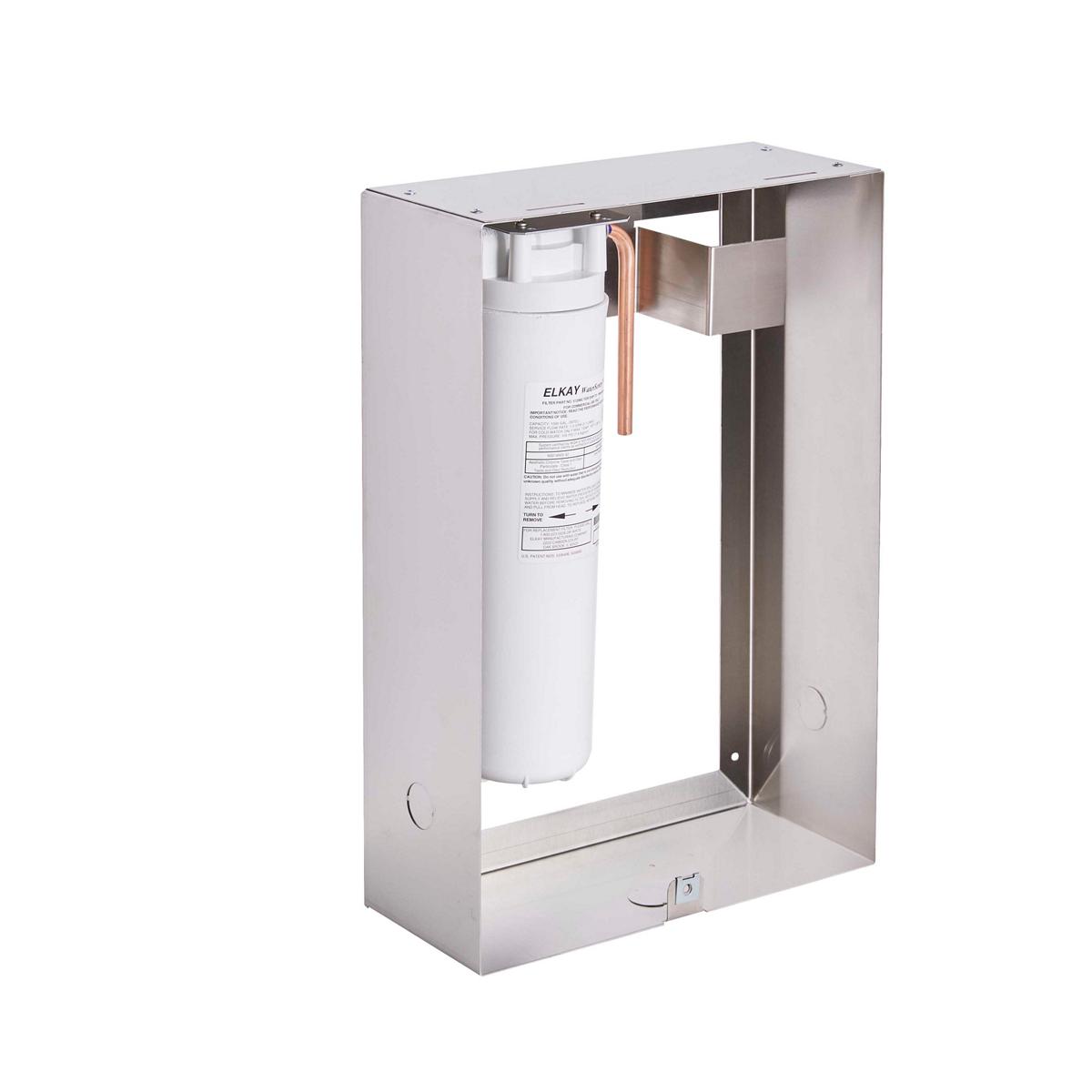 Stainless steel filtration unit with white cylindrical filter cartridge and copper tubing mounted inside protective metal hou