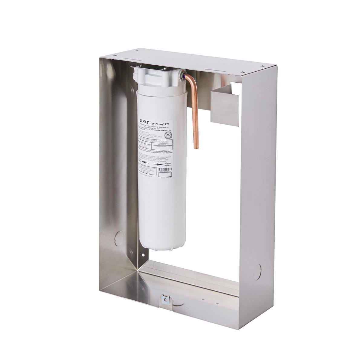 Stainless steel filtration housing with white cylindrical filter cartridge and copper tubing connection inside protective met