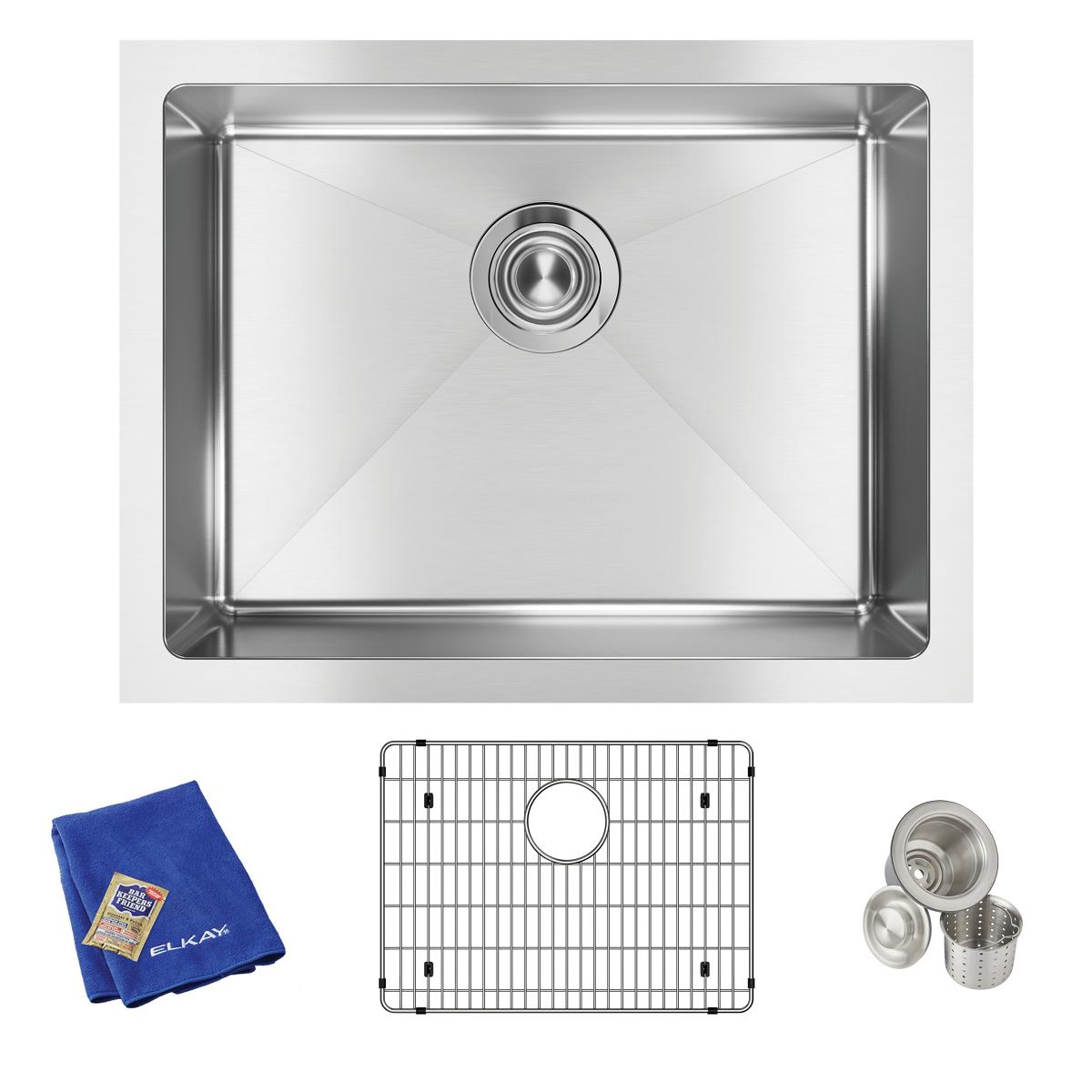 Stainless steel undermount sink with rounded corners, drain opening, and included grid, strainer basket, and blue cloth.