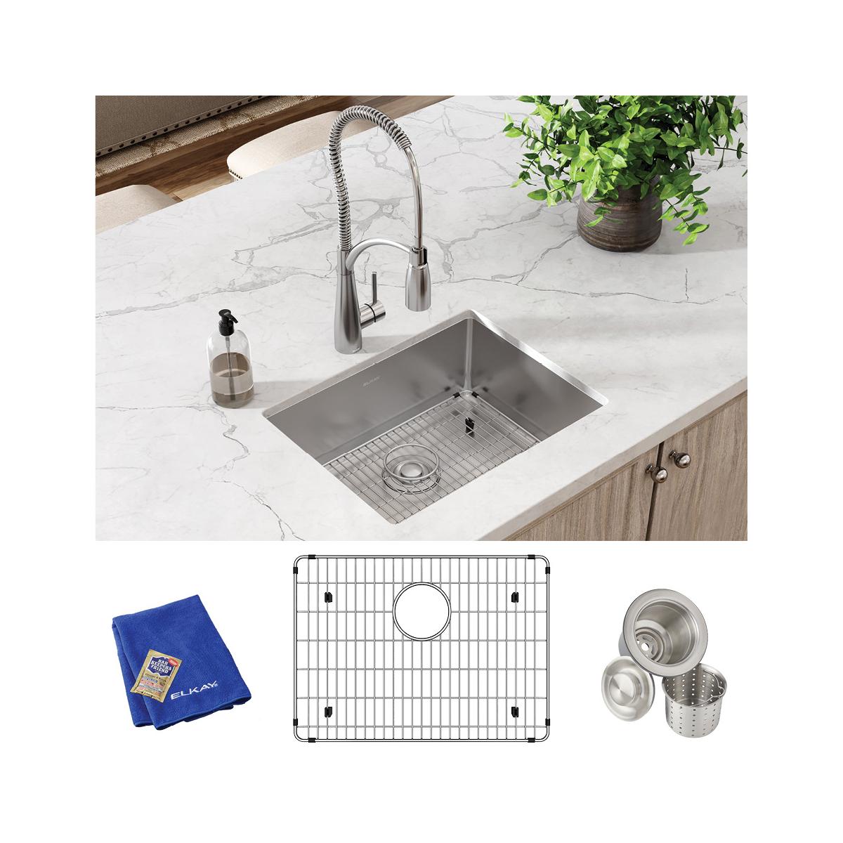Stainless steel undermount sink with rounded bowl installed in white countertop, includes faucet, grid, strainers, and blue c