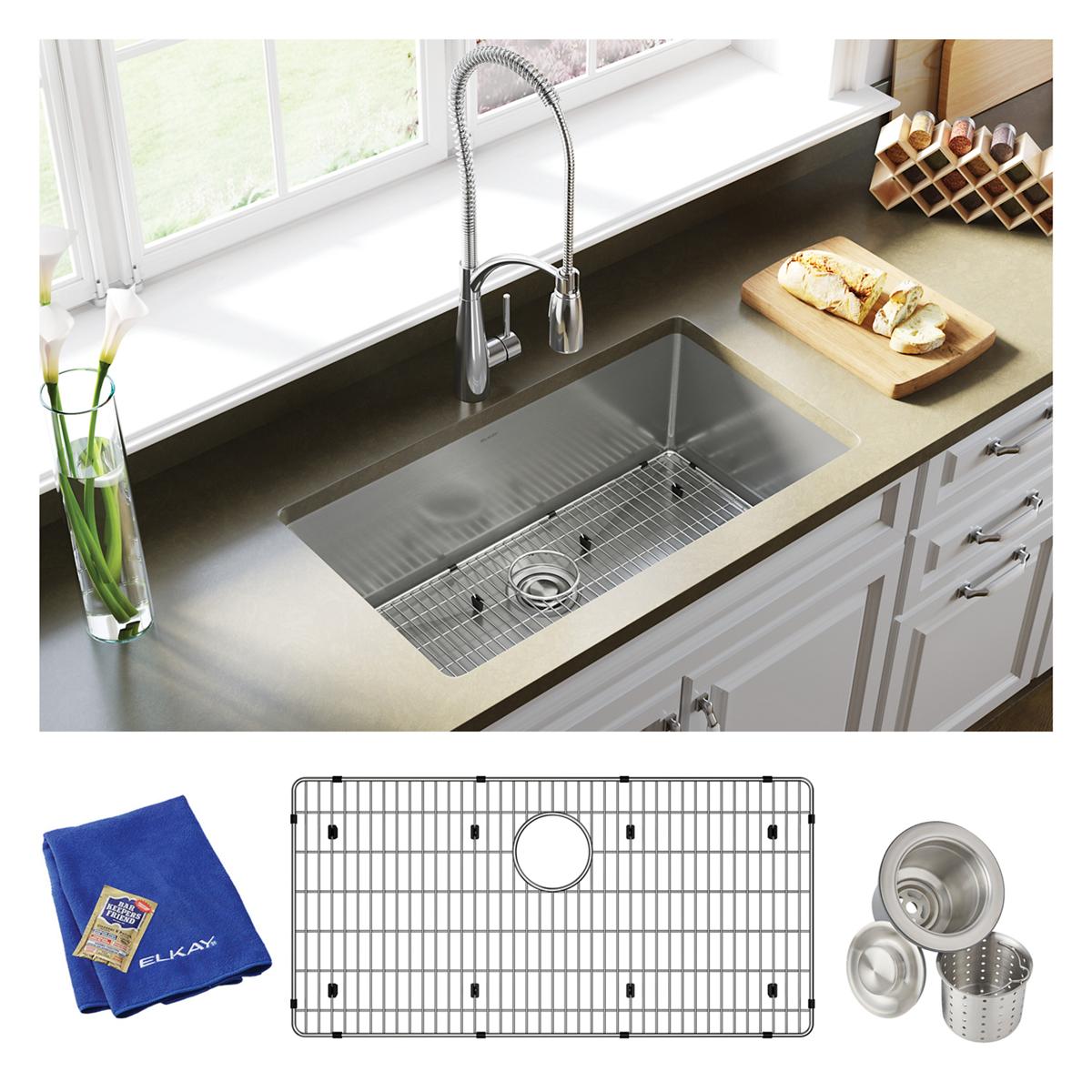Stainless steel single bowl undermount sink with faucet, grid, strainer basket, and blue cloth included.