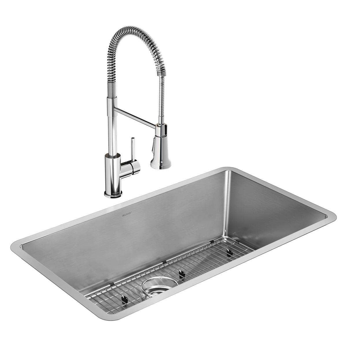 Stainless steel undermount sink bowl with grid insert and chrome pull-down faucet with coiled hose.
