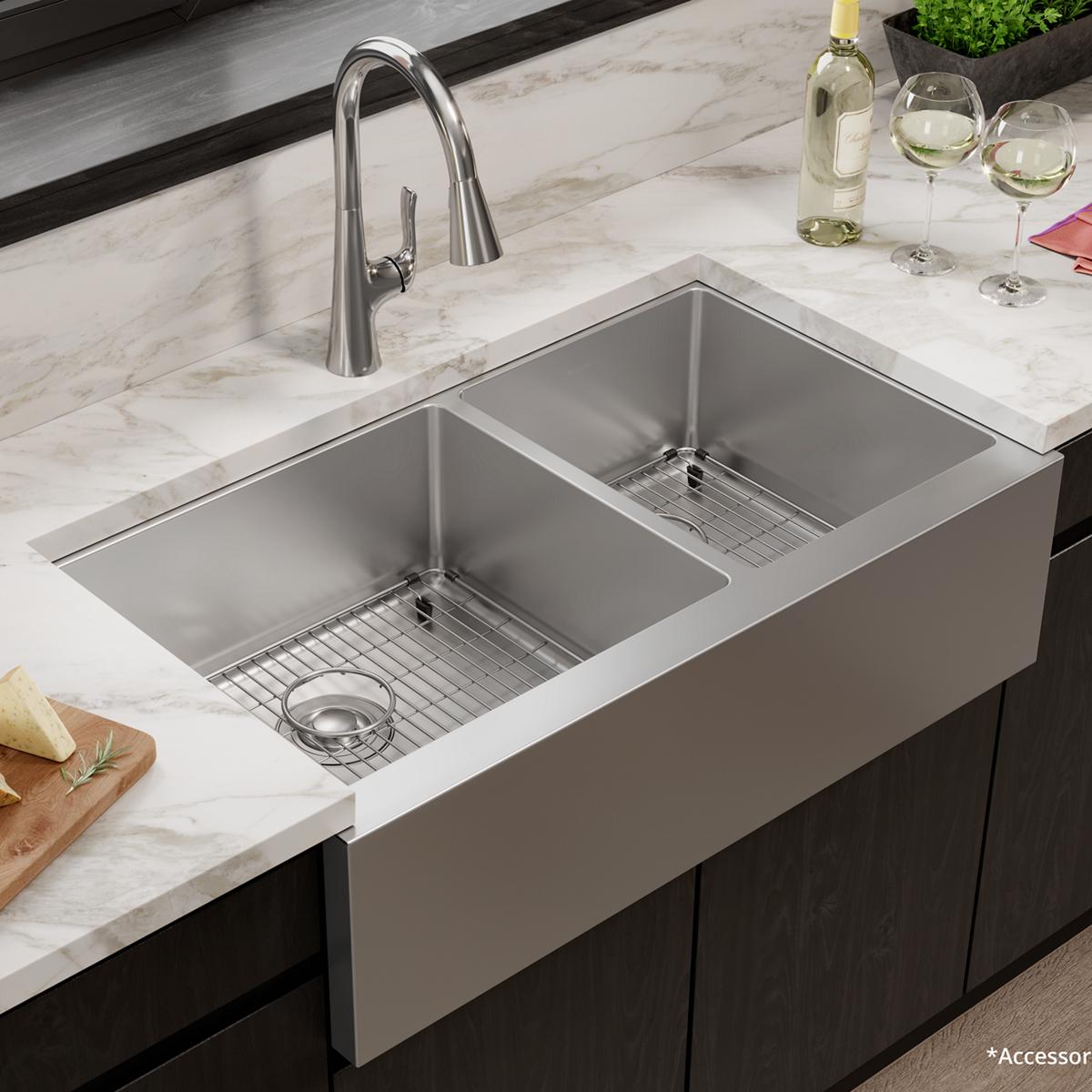 Stainless steel double bowl farmhouse sink with two equal compartments, metal grid inserts, and chrome pull-down faucet on ma