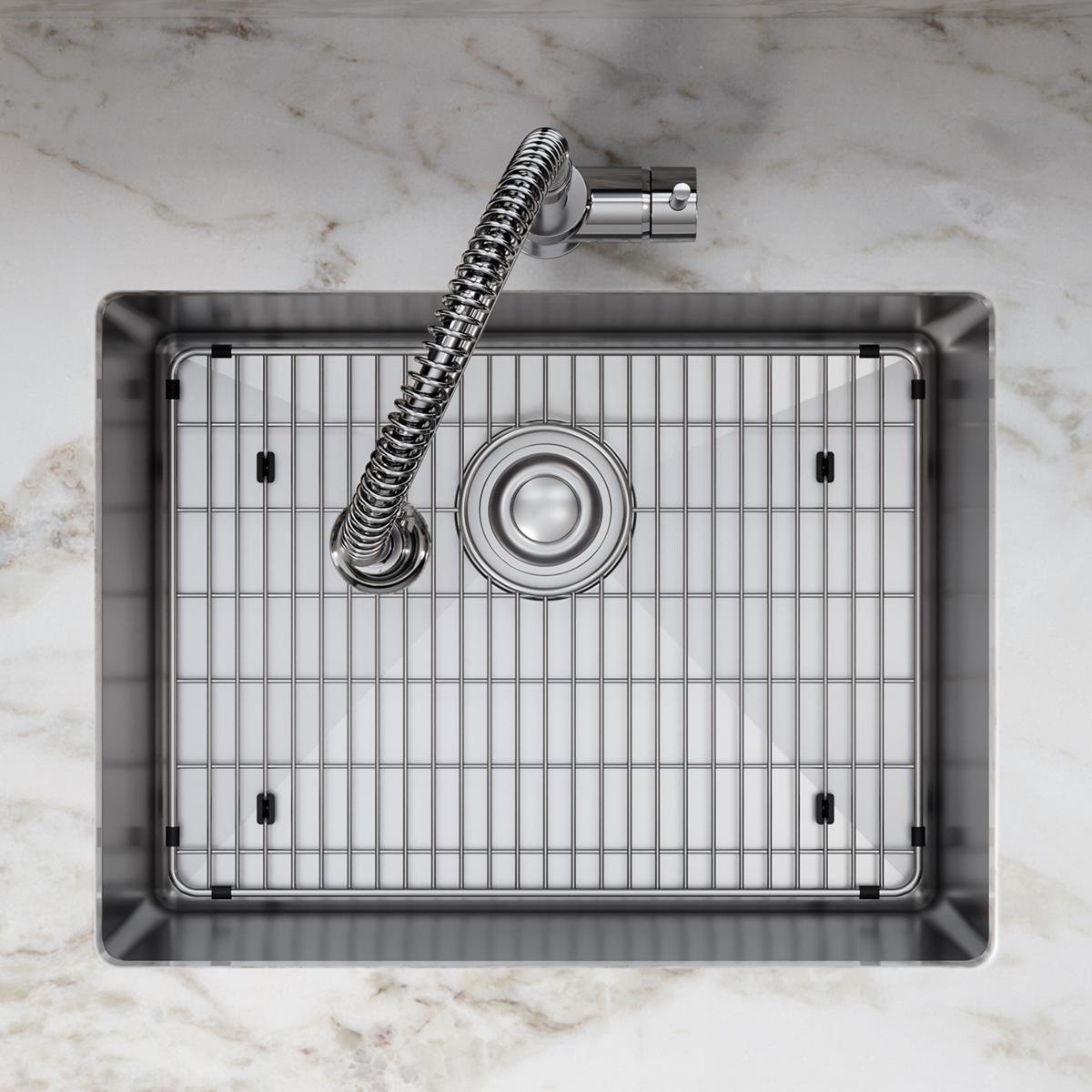 Stainless steel sink basin with bottom grid, center drain, and spiral faucet, viewed from above.