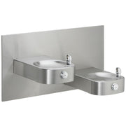 Stainless steel bi-level water fountain with two drinking basins mounted on gray panel backplate.