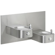 Stainless steel bi-level drinking fountain with two oval basins mounted on gray panel with chrome faucets.