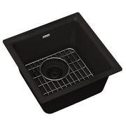 Black quartz single bowl bar sink with stainless steel grid and drain strainer.