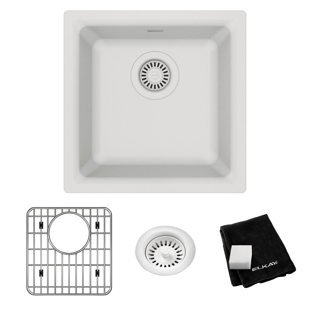 White quartz single bowl bar sink with strainer, shown with protective grid and black cloth.