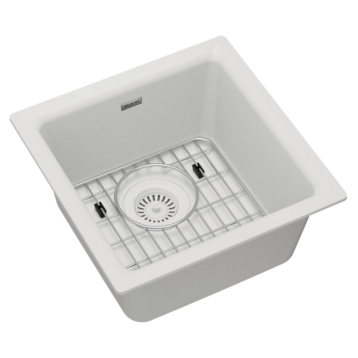 White quartz single bowl bar sink with stainless steel bottom grid and circular drain strainer.