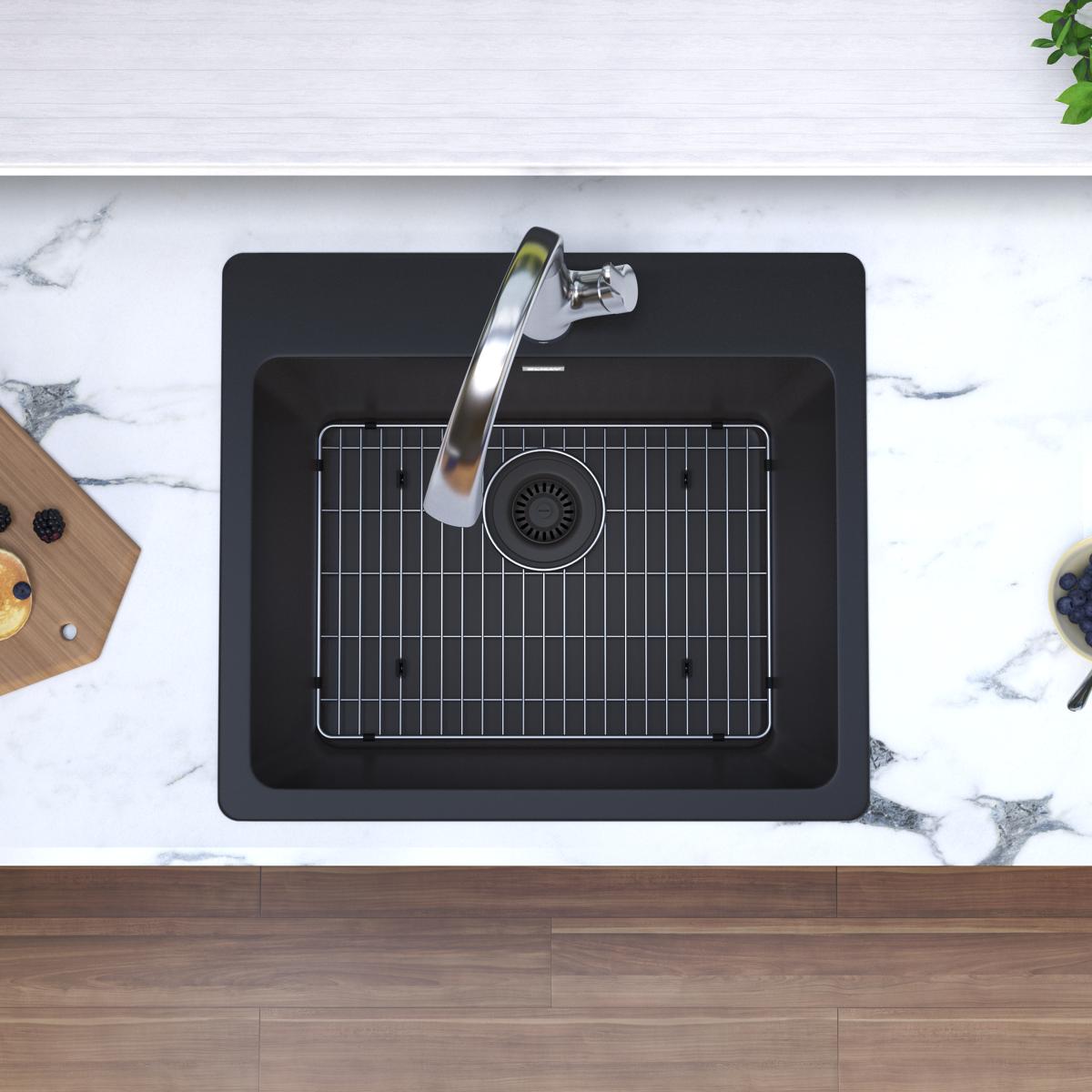Black quartz drop-in sink with single bowl, metal drain grid, and chrome filtered faucet, shown from above in countertop inst