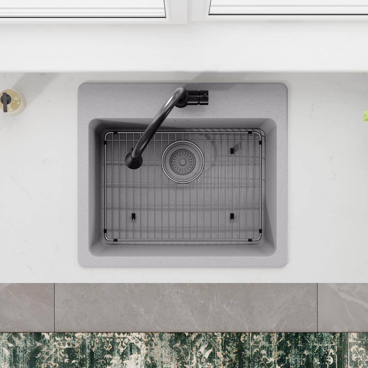 Stainless steel sink grid with vertical wire pattern and mounting brackets for basin protection.