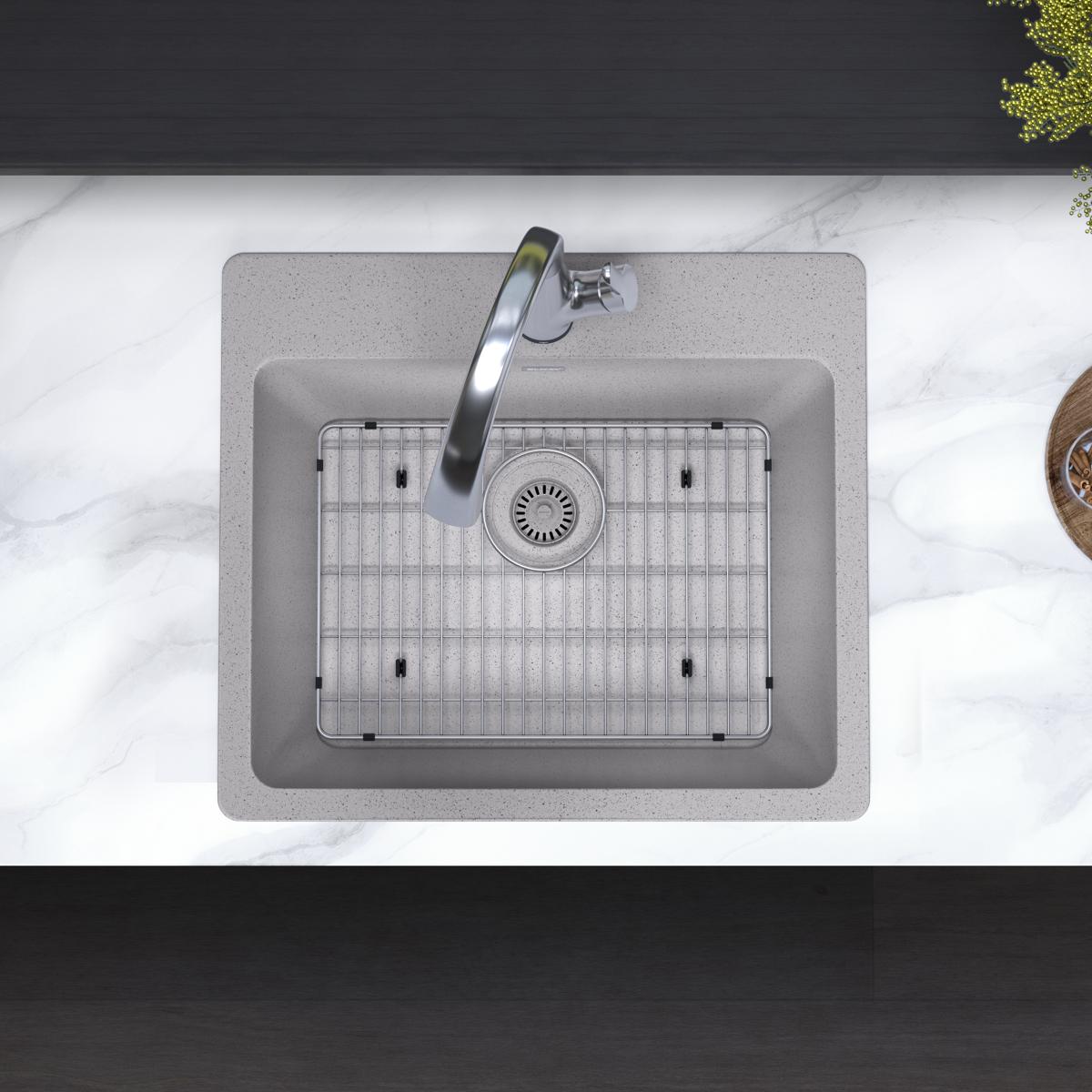 Greystone quartz drop-in sink with single bowl, grid insert, drain, and curved filtered faucet installed in countertop.