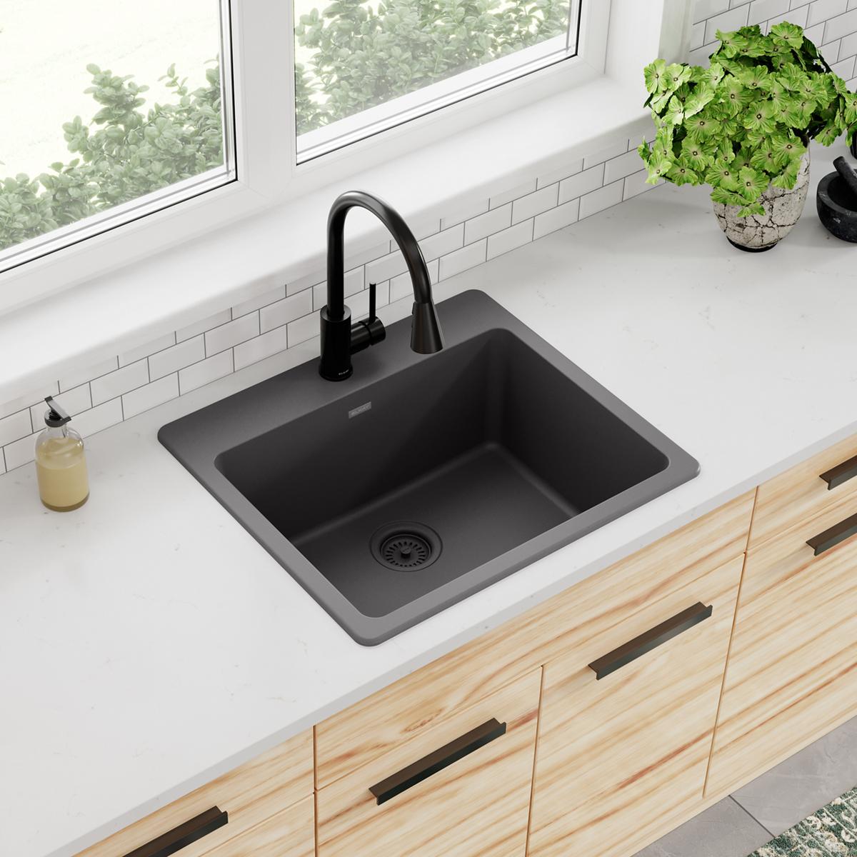 Dusk gray quartz drop-in sink with single rectangular bowl and black pull-down faucet installed in white countertop.