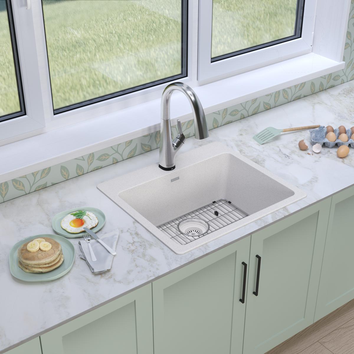 White quartz drop-in sink with single bowl and stainless steel filtered faucet installed in marble countertop.