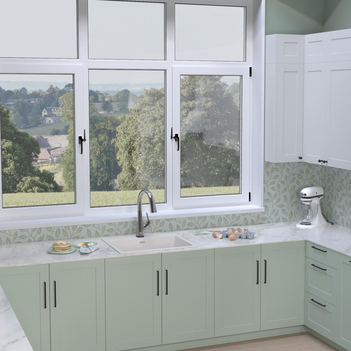 White quartz drop-in sink with single bowl and filtered faucet installed in green cabinetry beneath kitchen windows.