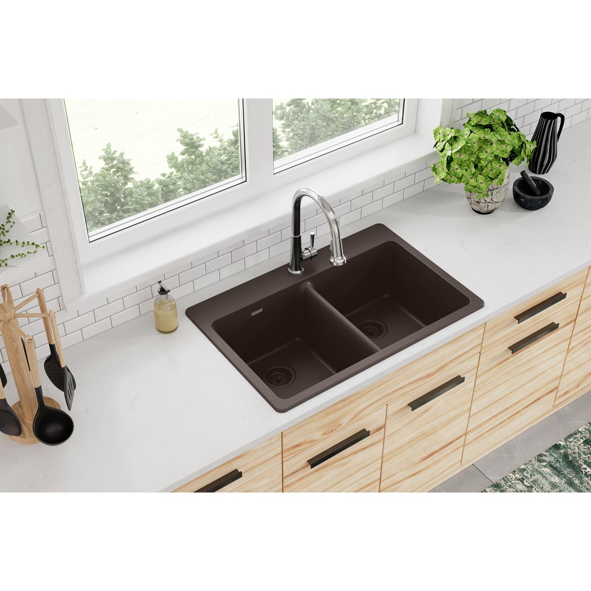 Mocha quartz drop-in sink with two equal rectangular bowls installed in light wood kitchen cabinet.