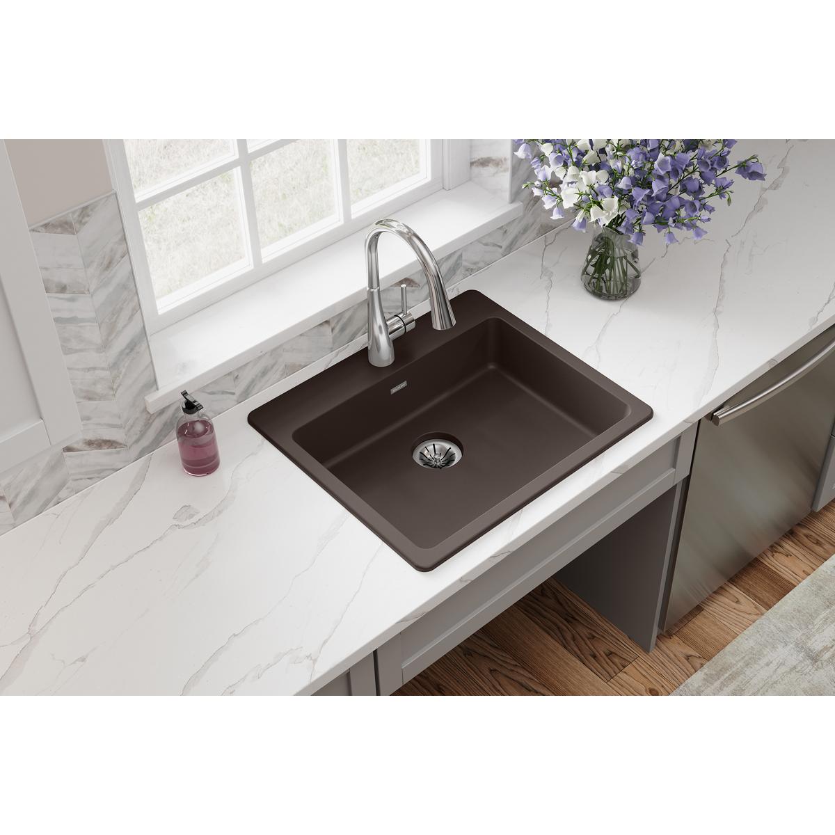 Mocha quartz drop-in sink with single rectangular bowl and chrome faucet installed in white countertop.