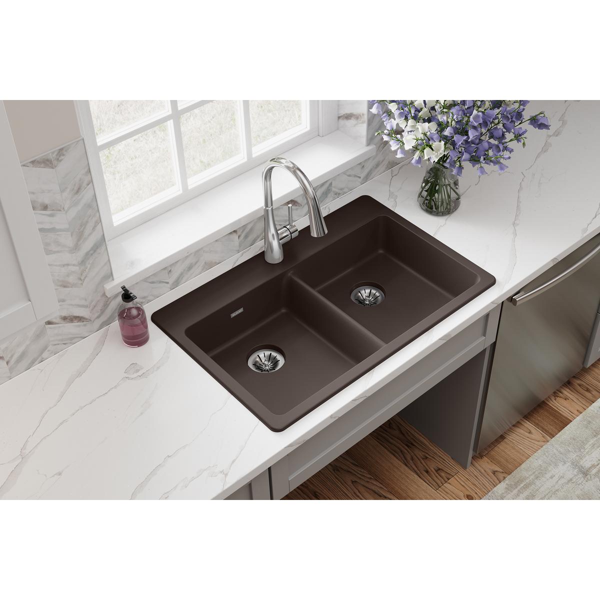 Mocha quartz double bowl drop-in sink with two drain openings and chrome faucet installed in white countertop.