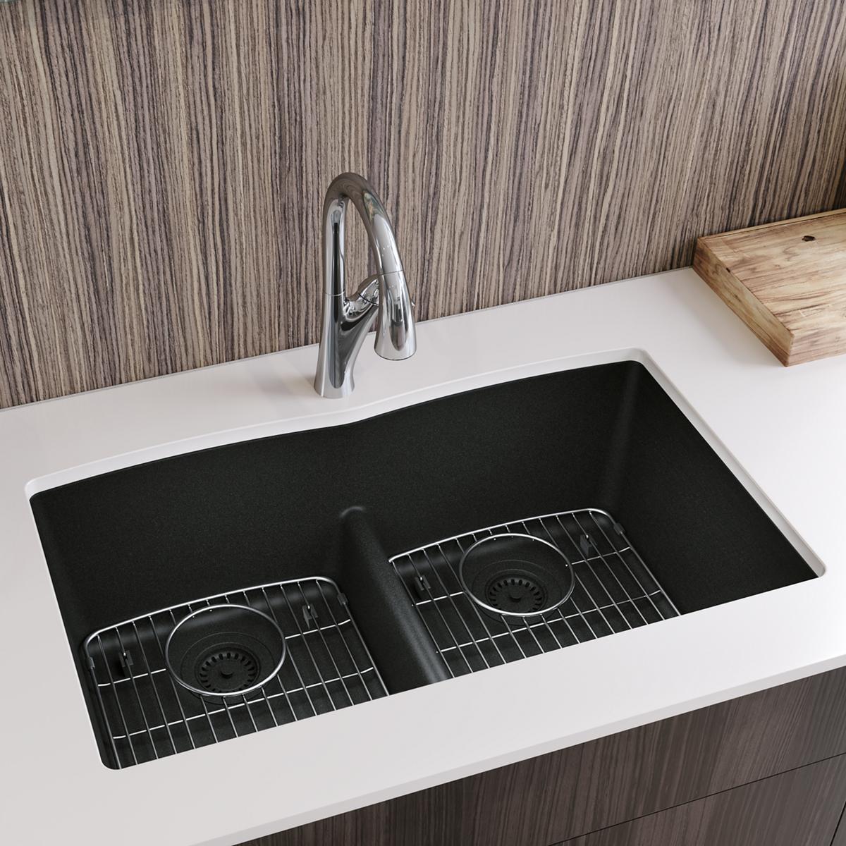 Black quartz undermount kitchen sink with two equal bowls, divider, stainless steel grids, and drain strainers.