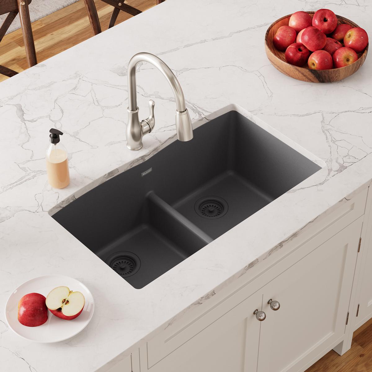 Dusk gray double bowl undermount sink with divider installed in white marble countertop, stainless steel faucet visible.