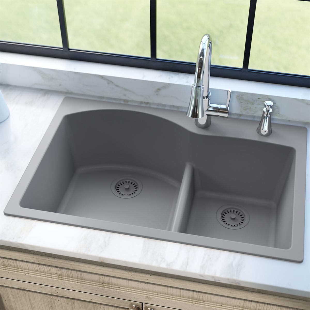 Greystone polymer double-bowl kitchen sink with disposer flange, basket strainer, and rubber stopper in left basin.