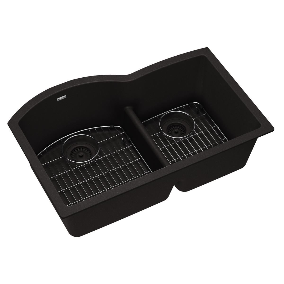 Black quartz double bowl undermount sink with offset basins, metal grids, and drain strainers.