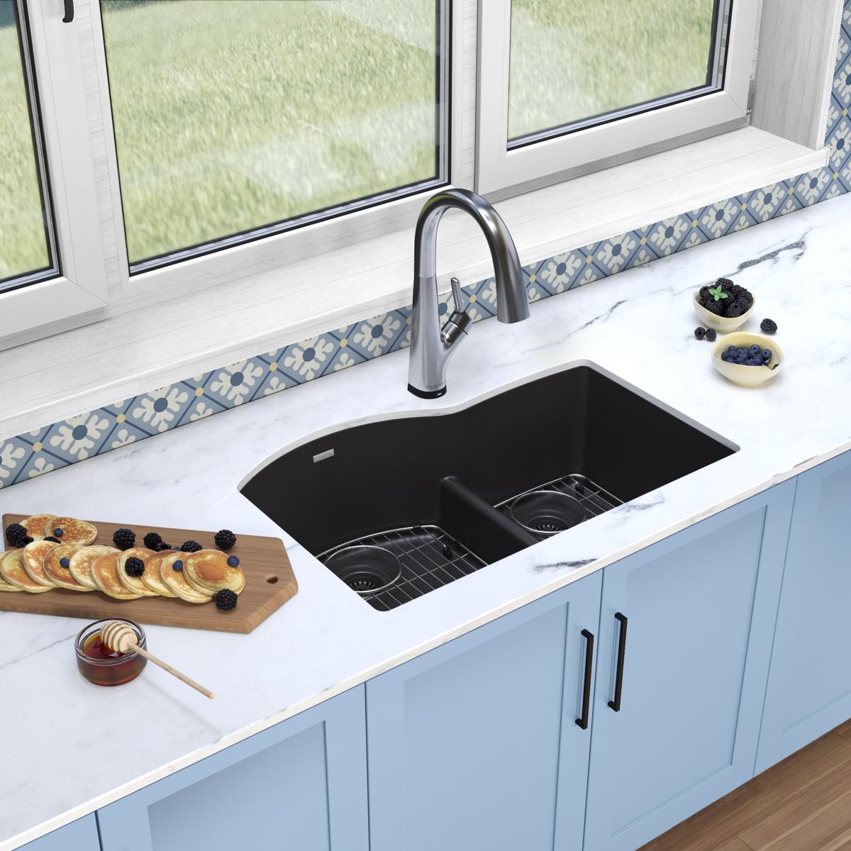Black quartz double bowl undermount sink with stainless steel pull-down faucet installed in white countertop.