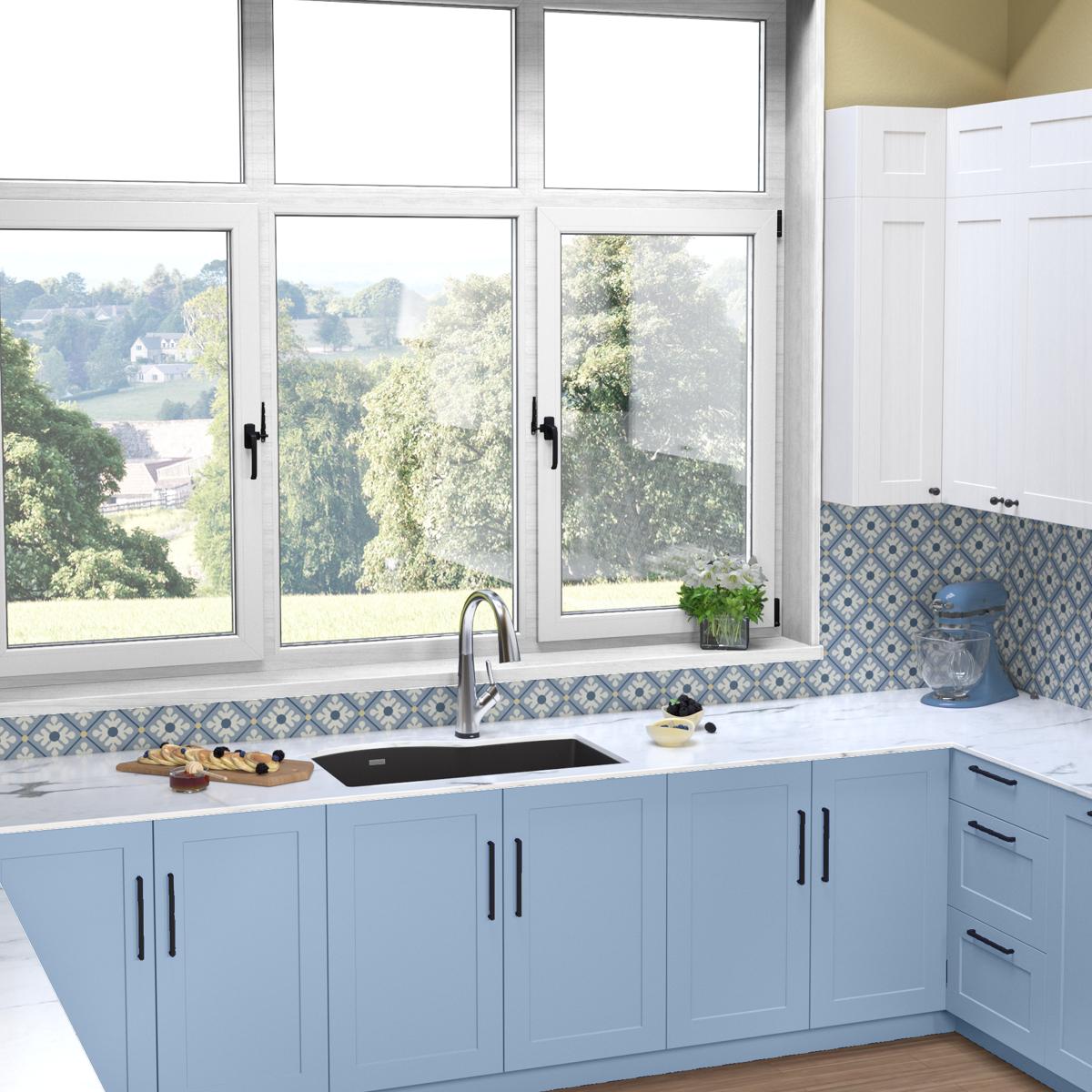 Black quartz double bowl undermount sink with stainless steel filtered faucet installed in blue kitchen cabinets.