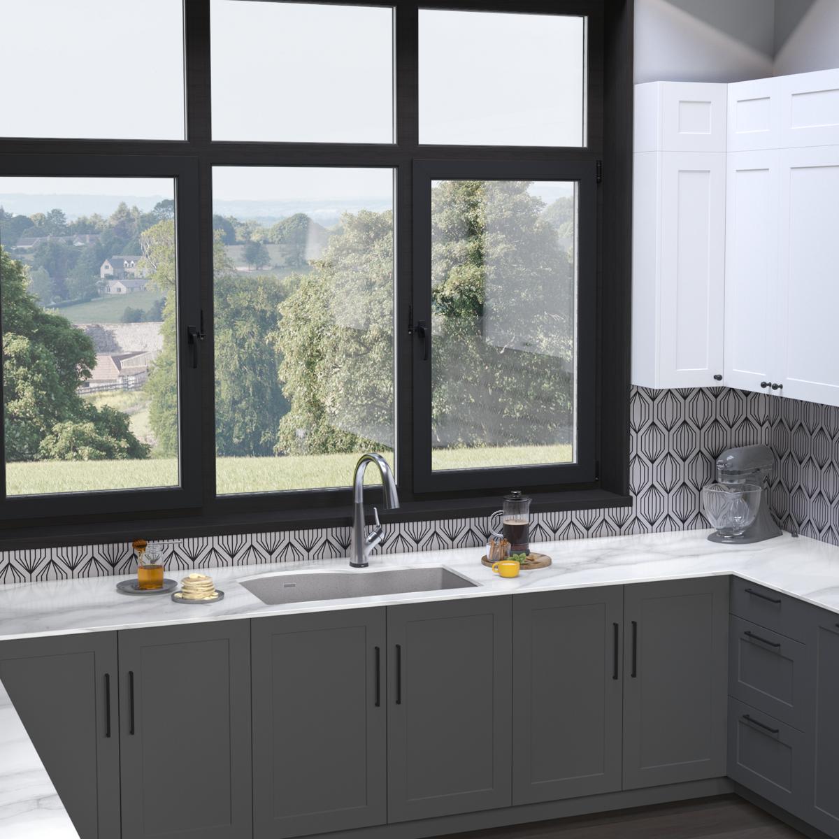 Greystone quartz double bowl undermount sink with filtered faucet installed in dark cabinetry under window.