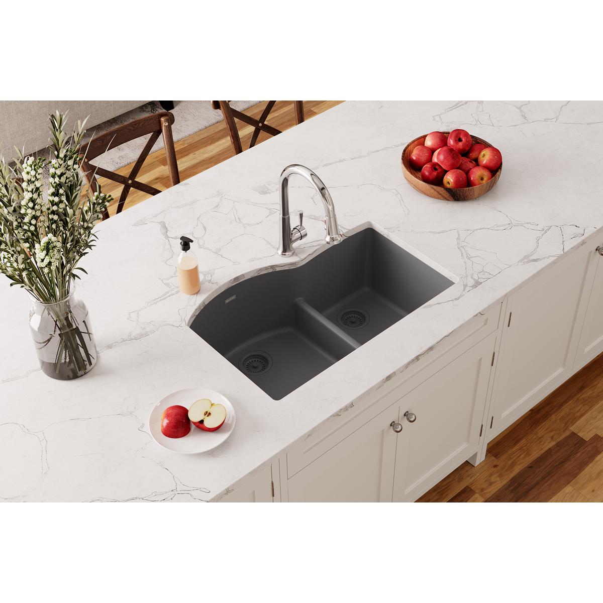 Dusk gray double bowl undermount sink with divider installed in white quartz countertop, paired with chrome faucet.