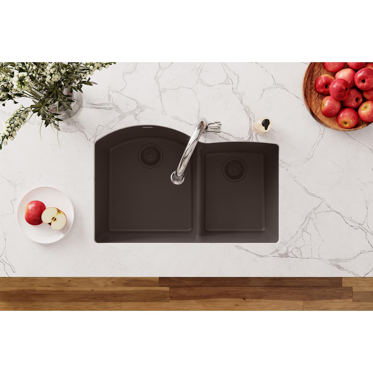 Mocha polymer kitchen sink with dual basins, faucet, and disposer flange with removable strainer basket installed in countert