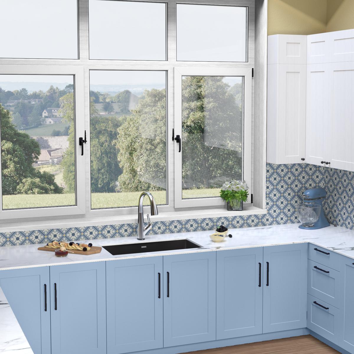 Black quartz undermount sink with chrome filtered faucet installed in white countertop with blue cabinetry.