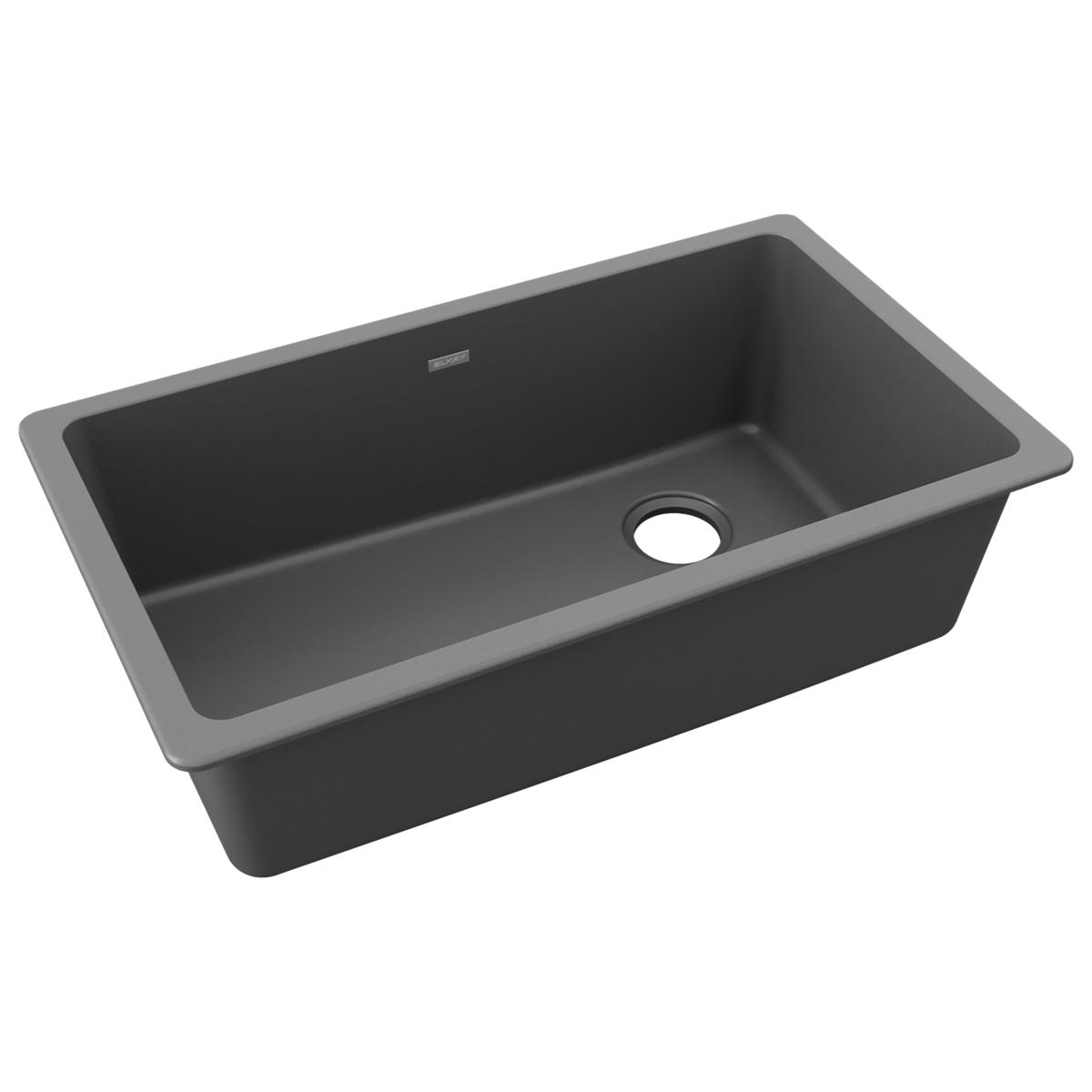 Dusk gray quartz single bowl undermount sink with drain hole and sloped bottom.