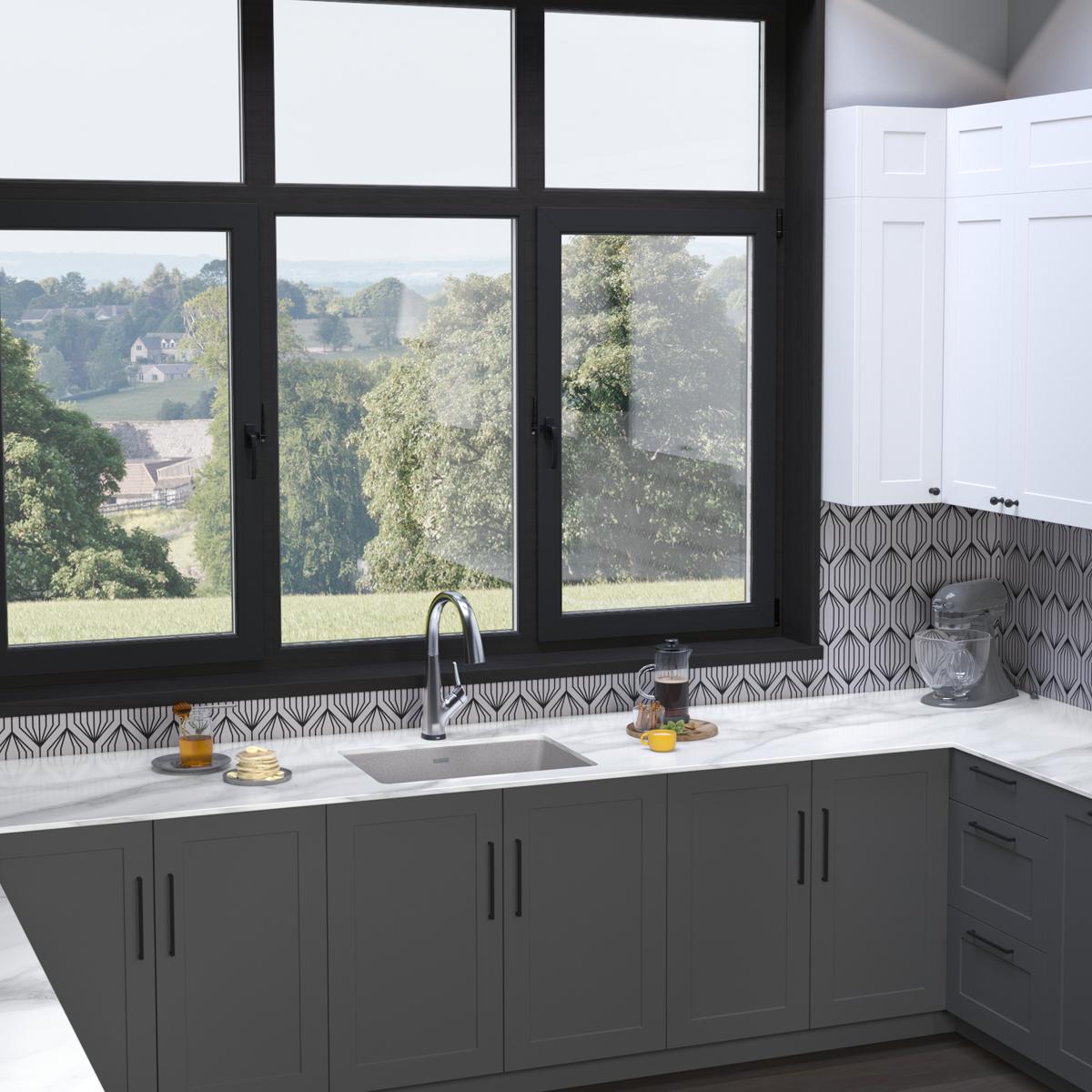 Greystone quartz single bowl undermount sink with filtered faucet installed in white countertop with dark cabinetry.