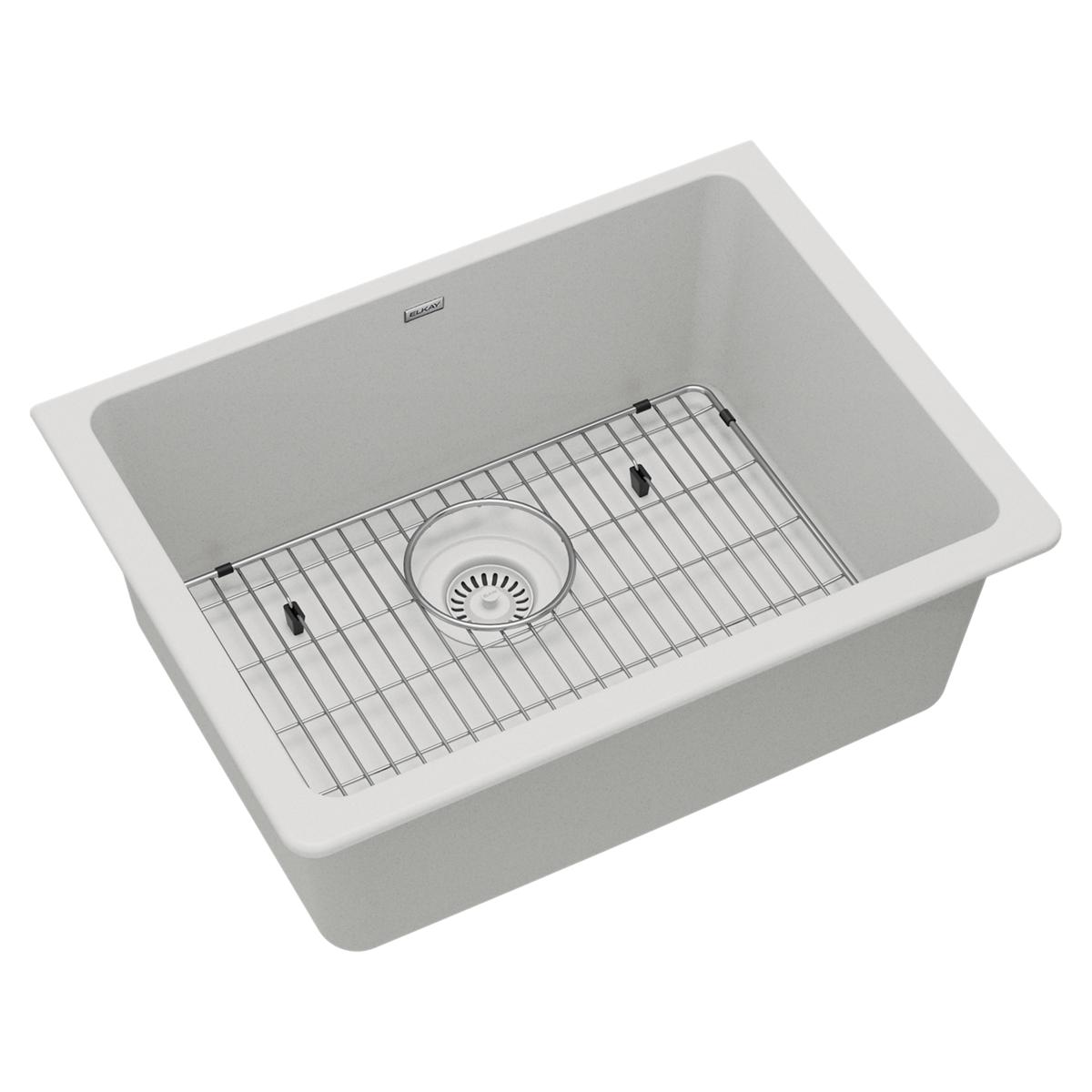 White single bowl undermount sink with stainless steel grid and drain strainer visible.