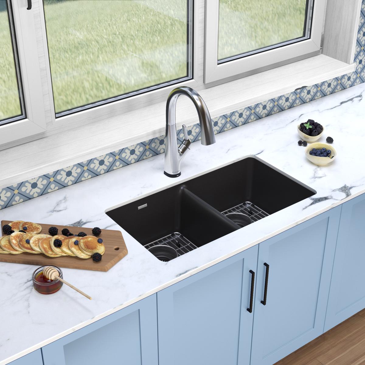 Black quartz undermount double bowl sink with stainless steel filtered faucet installed in white countertop.