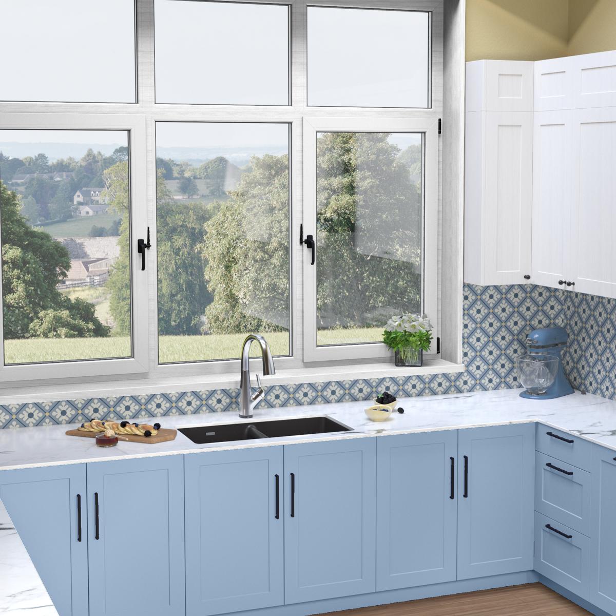 Black quartz double bowl undermount sink with filtered faucet installed in white countertop with blue cabinetry.