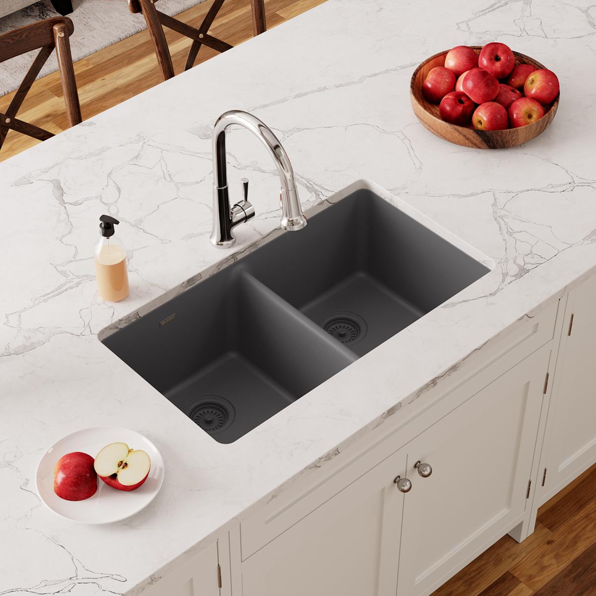 Dusk gray quartz double bowl undermount sink installed in white marble countertop with chrome faucet.
