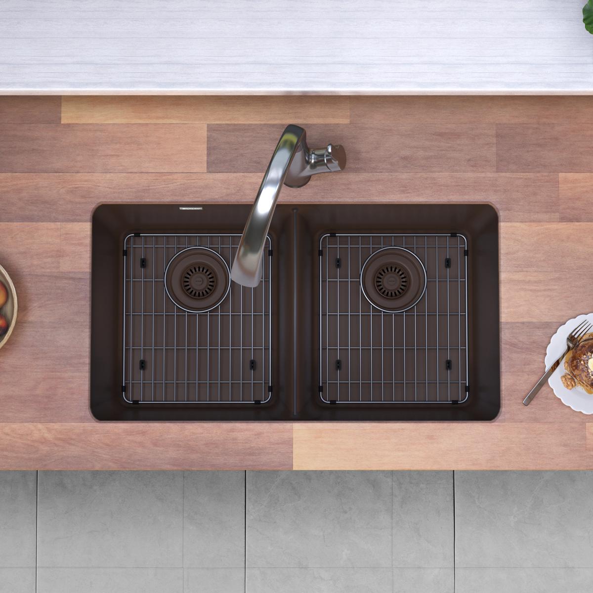 Mocha quartz double bowl undermount sink with two grid inserts, dual drains, and arched filtered faucet installed in wood cou
